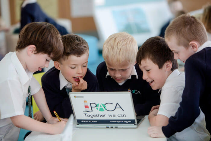 group of students working together on a laptop