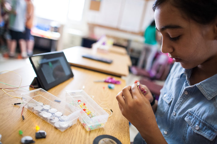 Girl using tablet to build a science project