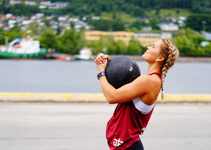 teacher with a ball in her arms