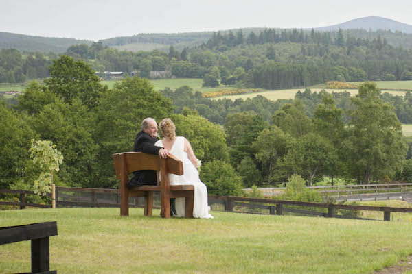 wedding couple enjoying the view from a garden bench