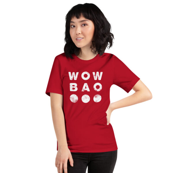 A female presenting person with a red tshirt with a white Wow Bao Logo in the center.