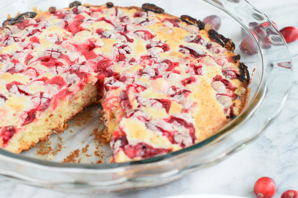 Crustless Cranberry Pie in a pie dish with one slice removed