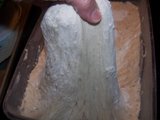 grabbing a handful of dough to make bread