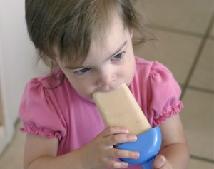 Toddler eating popsicle