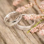 Silver wedding rings on a wooden background