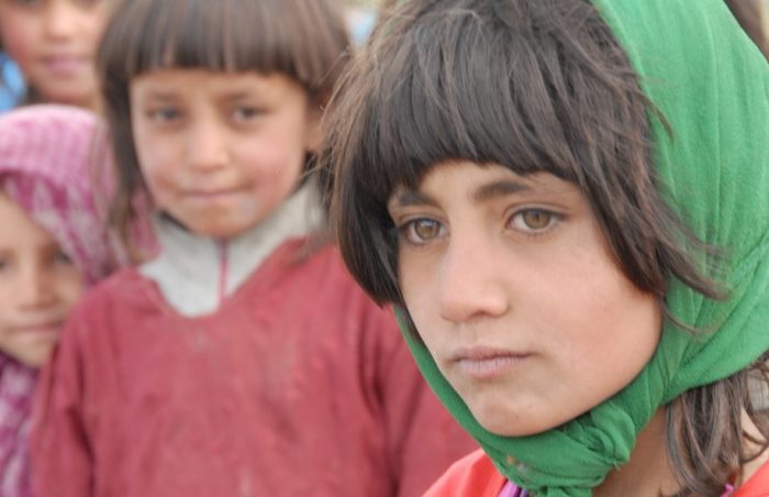 Afghani orphan schoolgirl in a green headscarf