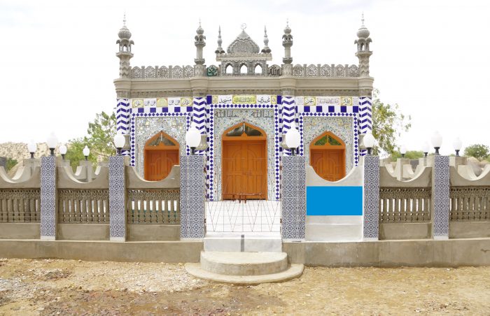 Small mosque in Sindh, Pakistan, with large courtyard and decorative tilework.