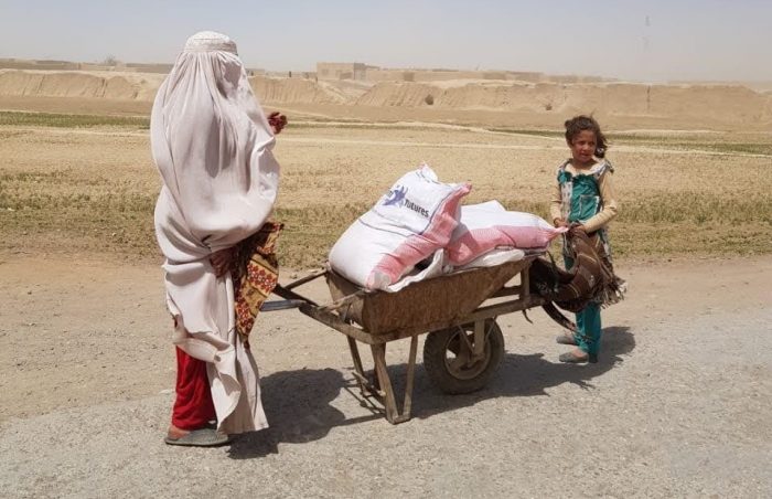 Afghani refugees load their 50kg ration packs onto a barrow to return home, Pishin, Pakistan.