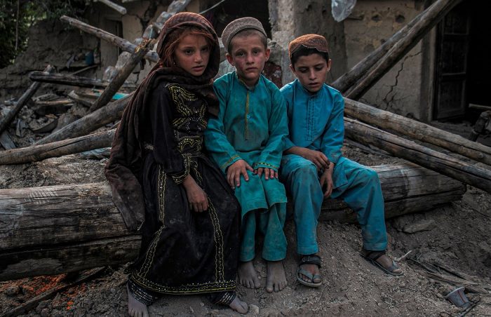 Poor and needy Afghani children huddle in the wreckage caused by earthquake, Patika, Afghanistan