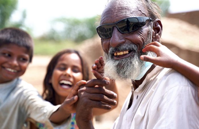Smiling sardar with family after cataract eye operation in Pakistan