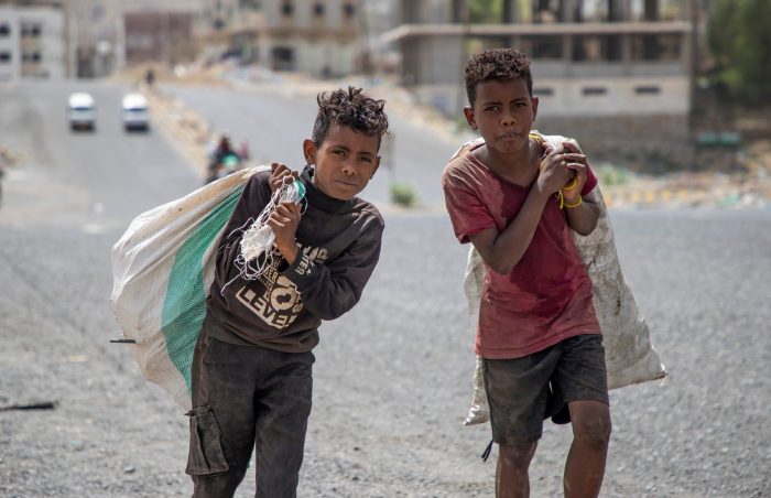 2 boys in Yemen make a living by collecting and then selling scrap haberdashery they forage from the garbage dumps