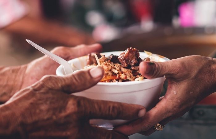 Giving free hot cooked food to the poor and needy.