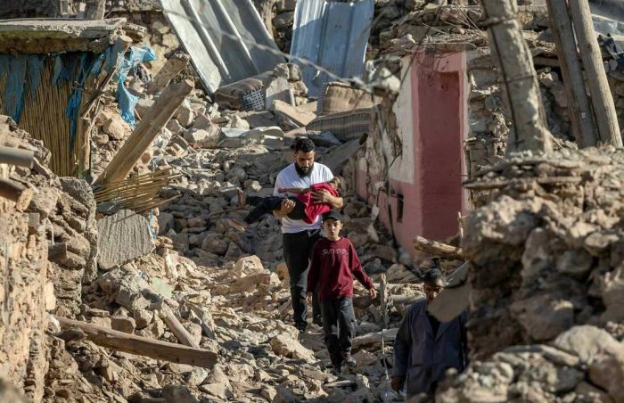 Morocco Earthquake. A father rescues his children from the rubble. Getty Images. 3x2