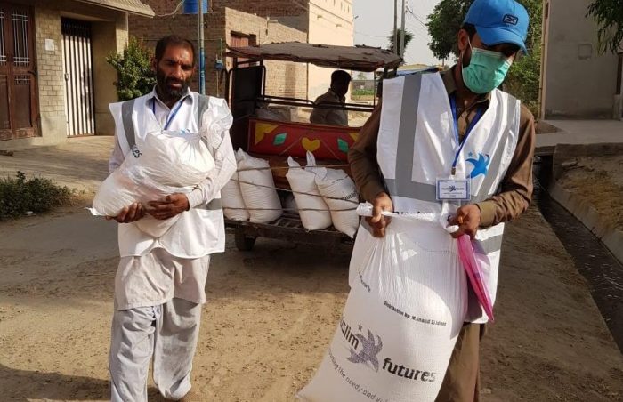 Volunteers distributing wheat packs in southern Punjab, Pakistan