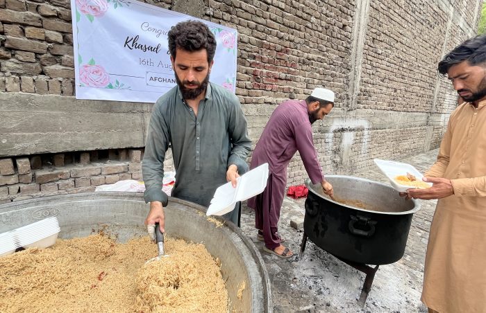 Serving rice and curry to 400 families in Afghanistan as a cooked hot food distribution for a Walima