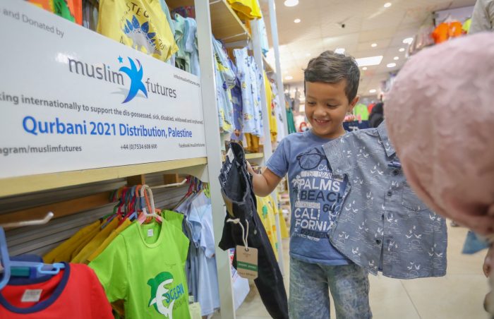 Sick children are taken to a clothing store to select new clothes on Eid in Ramallah, Palestine