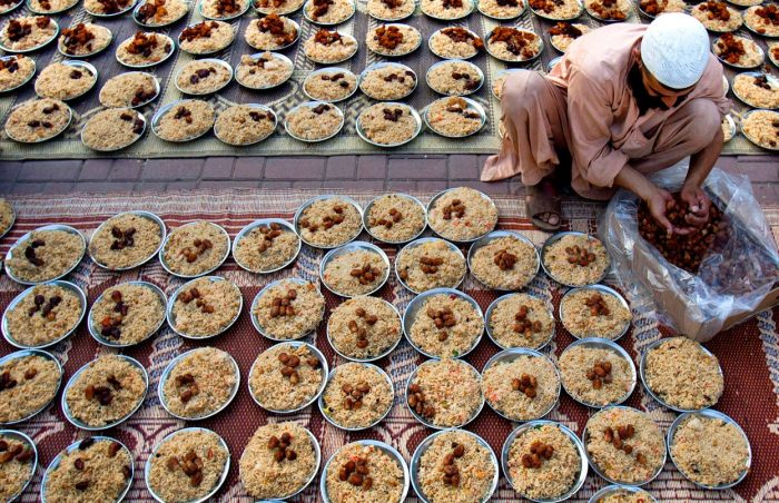 Plates of Iftar rice and dates being prepared ready for the opening of the fast in Afghanistan