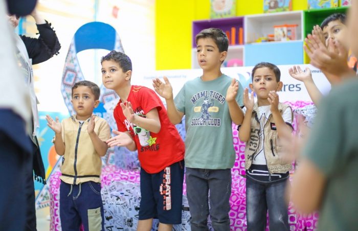 Children clap and play as they recieve Eid gifts at the Children's Cancer hospital, Gaza, Palestine