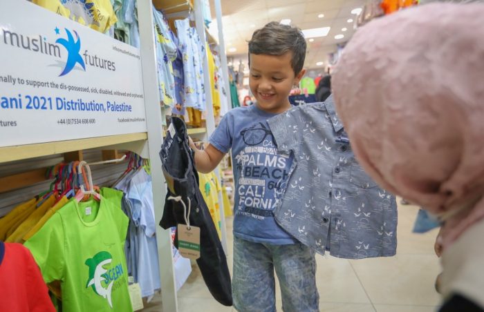 Boy recieves new Eid clothes in Palestine for children from the Children's Cancer hospital, Gaza.