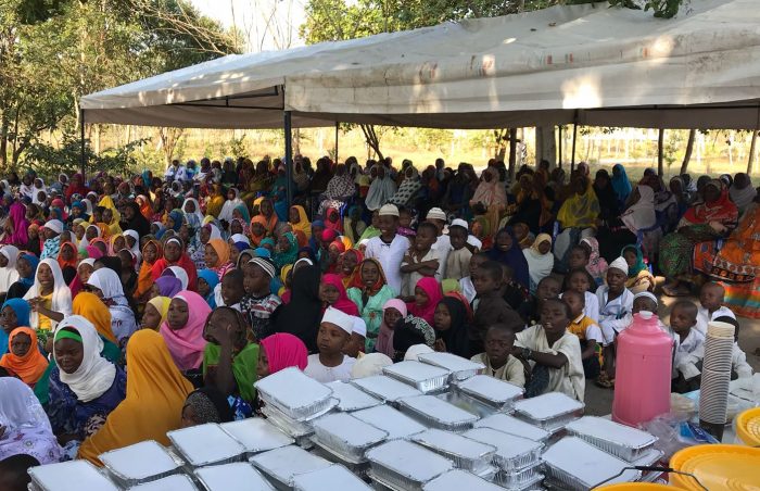 A whole village in Tanzania patiently awaits the distribution of hot cooked meals on Eid ul-Adha