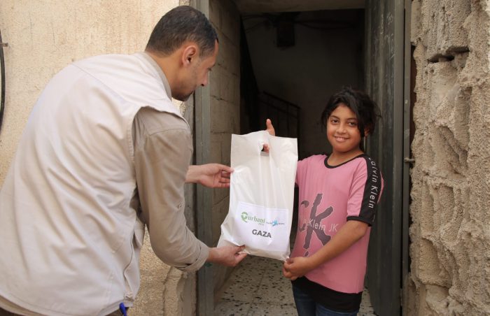 Girl receives her family's Eid ul-Adha Qurbani meat from Muslim Futures, in Gaza, Palestine in 2022