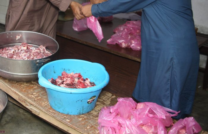 Preparing the Aqeeqah meat packs for the recipients in Pakistan.