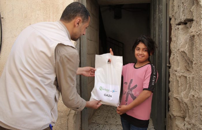 Girl receives her famil's Eid ul-Adha Qurbani meat from Muslim Futures, in Gaza, Palestine in 2022