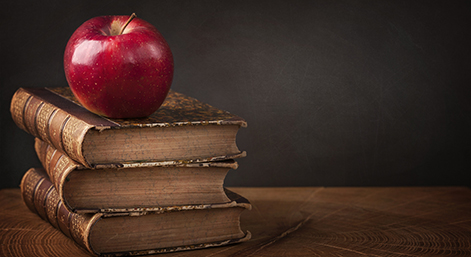 Stack of books and red apple