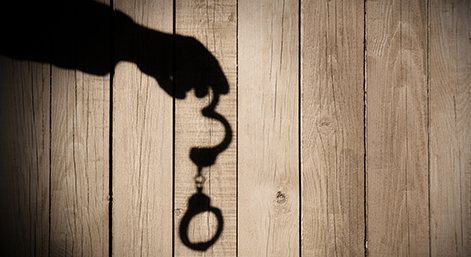 Male Hand with Handcuffs on Natural Wood Background, XXXL.