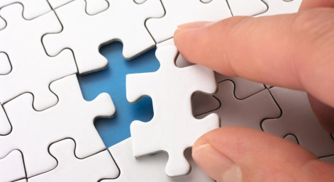 A person fitting the last puzzle piece.