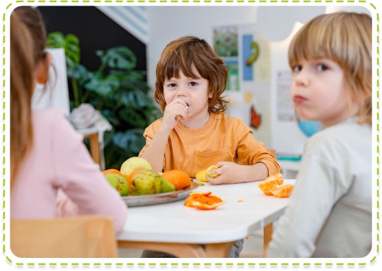 Children sitting at a table enjoying healthy snacks at Parcs Nursery, a top-rated nursery in Peterborough, UK, promoting balanced nutrition and social interaction.