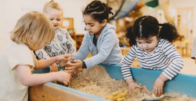 A group of children playing and learning with sand at Parcs Nursery, one of the leading nurseries in Peterborough, UK, fostering creativity and growth in a nurturing environment.