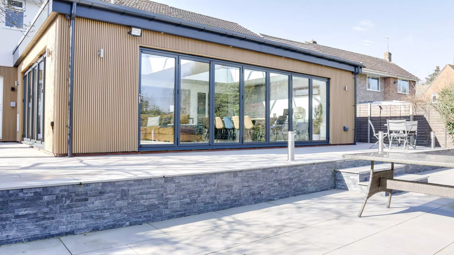 Flat roof orangery featuring grey lantern windows