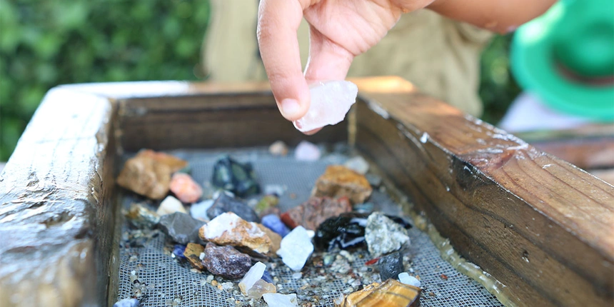 A child picking a gem from our gem minin sluice. 