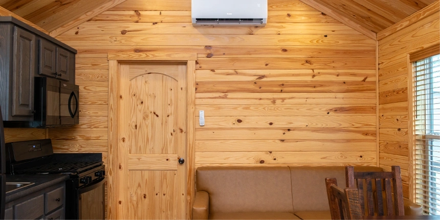 Living area in our Oak Trail Cabins including a sleeper sofa, and kitchen. 