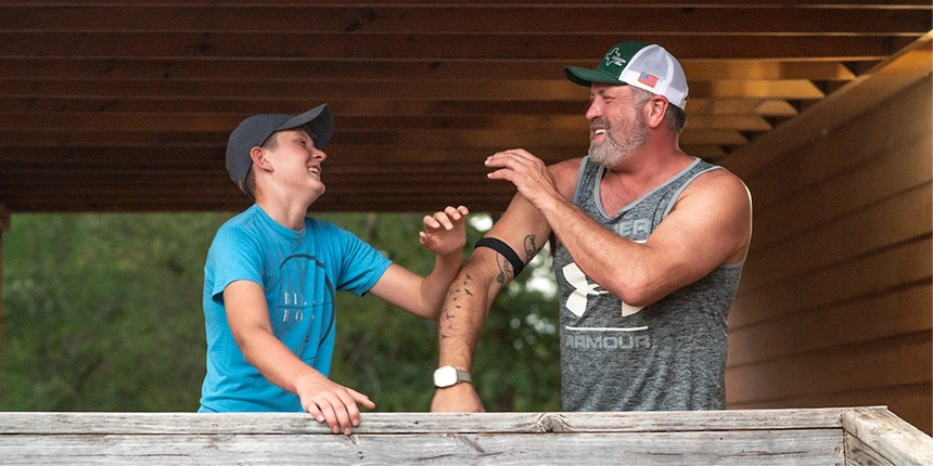 Campers laughing at their cabin.