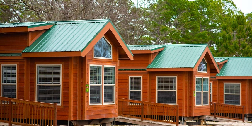 Piney wood cabins on a cloudy day, lined up.