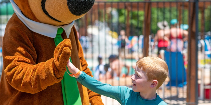 Camper high fiving Yogi Bear™!