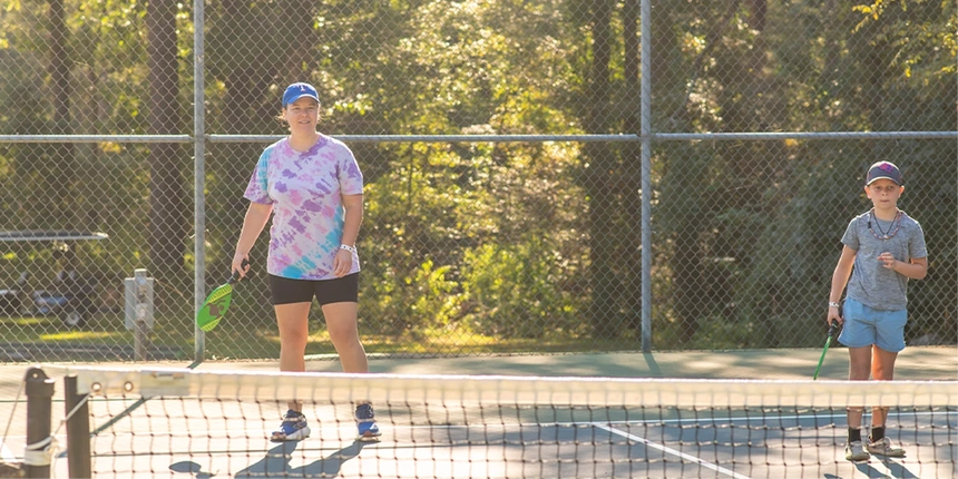 Campers playing pickleball at the pickleball courts.