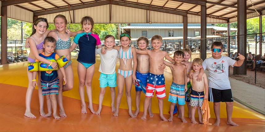 Campers enjoying the jumping pillow at our Piney Woods Camp-Resort. 