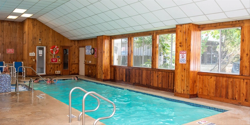 Indoor pool with kids playing in the water. 