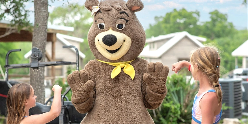 Cindy Bear™ with campers high fiving!