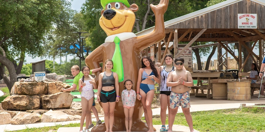 Kids posing in front of the Yogi Bear™ statue.