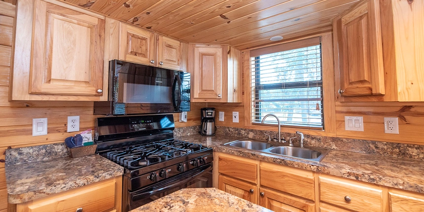 Full kitchen featuring an oven, stove, coffee maker, island, and more. 