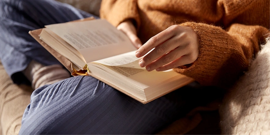 Reading a book at a cabin.