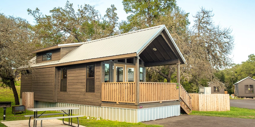 Outside space of the Hill Country Cottages that includes a picnic table, porch, and more!