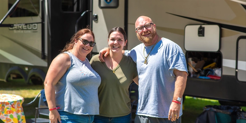 Campers in front of an RV at Tower Park Resort.