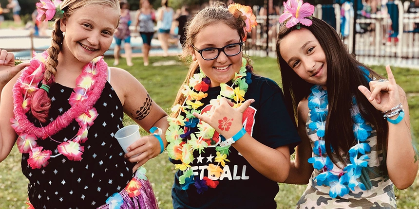 Campers wearing lei at our Luau events.