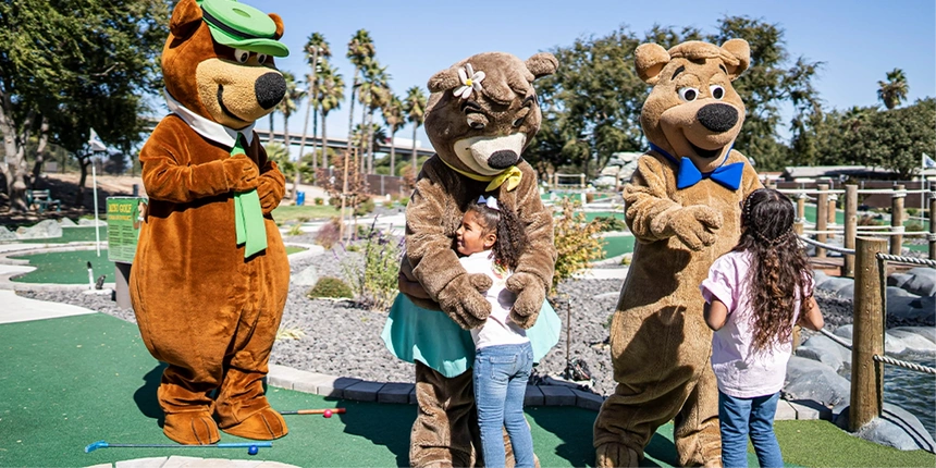 Campers and bears playing mini golf.