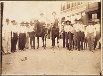 The unidentified corpse of an African American male with posse. Circa 1900, location unknown.